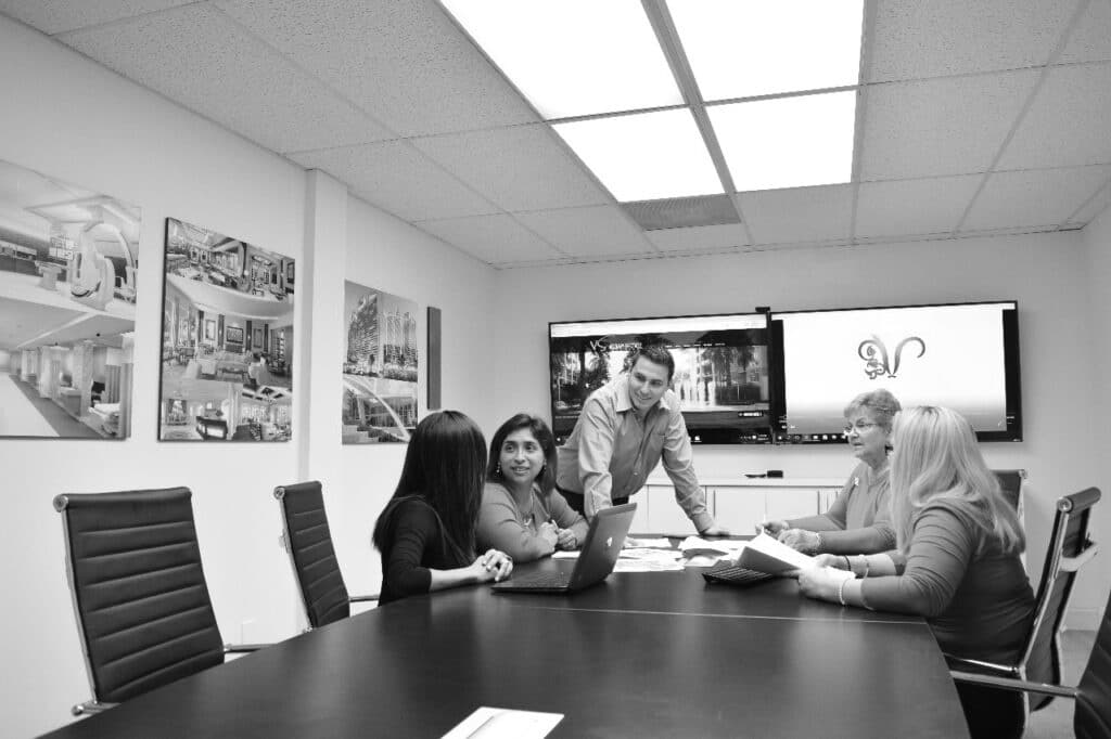 Black and white image of people working in an office